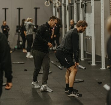 Coach with a client on training at CrossFit 749