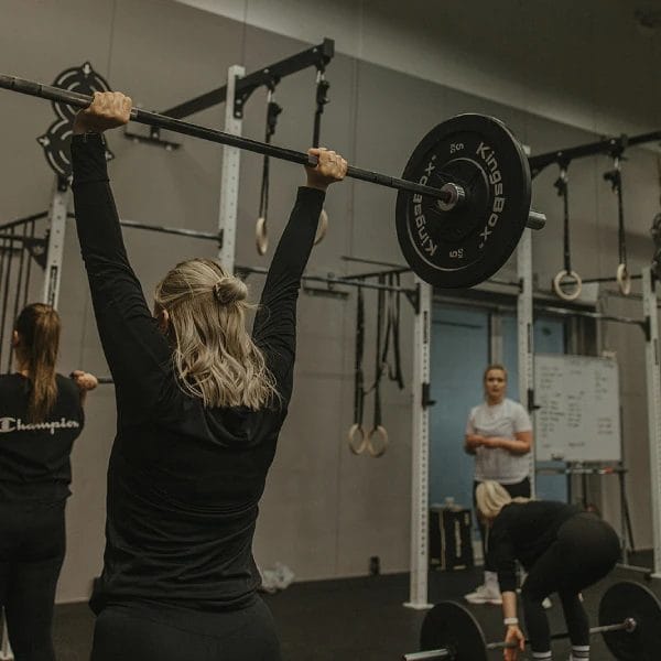 Women lifting barbell